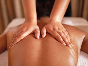 Therapist massaging guests back.